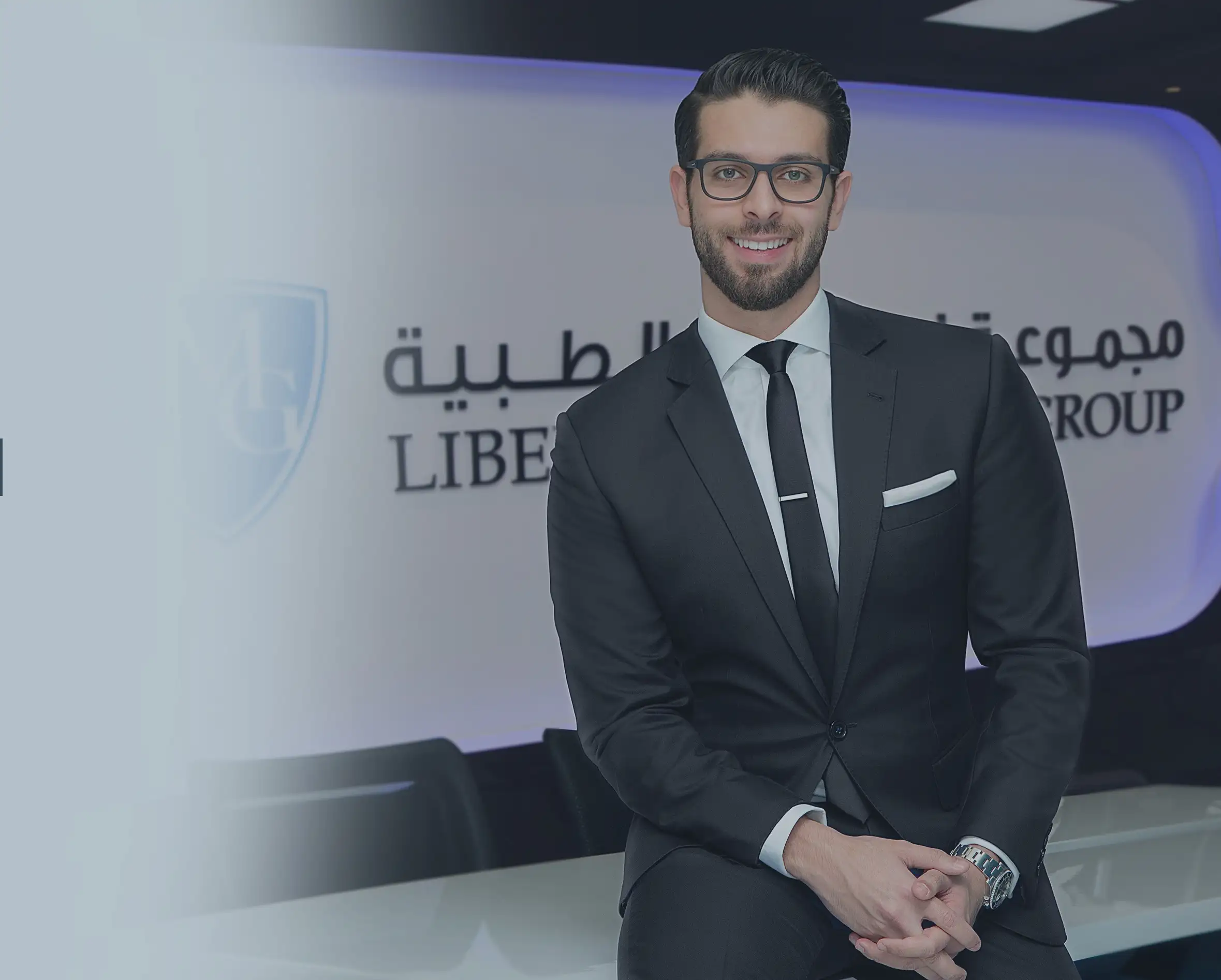 Dr. Mohammed Naji in front of the Liberty Medical Group sign