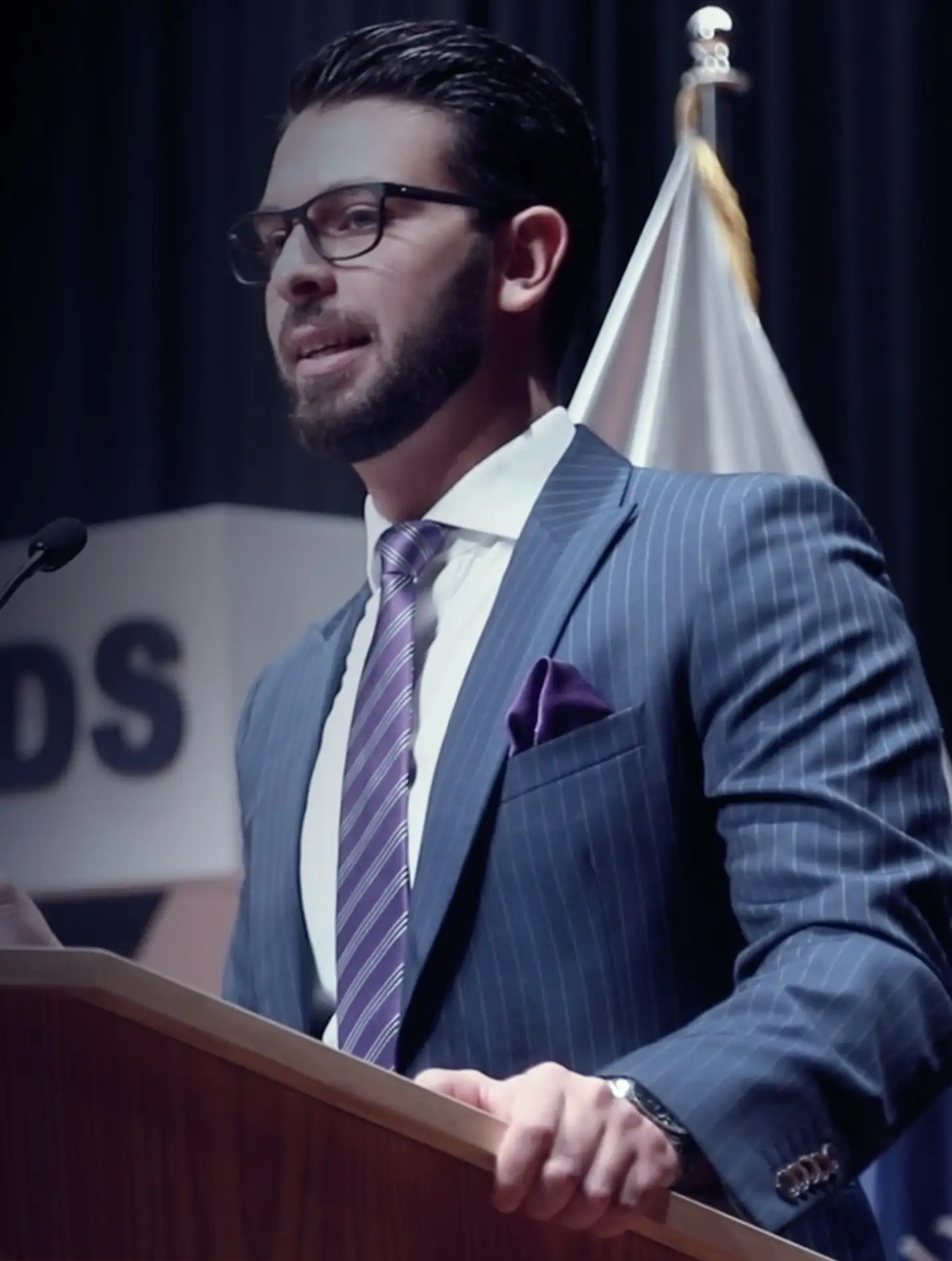 Dr. Mohammed Naji speaking at a lectern